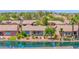 Aerial view of lakeside homes showing landscaping and tranquil water features at 42485 W Abbey Rd, Maricopa, AZ 85138