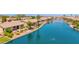 Aerial view of serene waterfront property featuring well-maintained landscaping and a tranquil lake at 42485 W Abbey Rd, Maricopa, AZ 85138