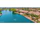 Breathtaking aerial view of waterfront homes, lush landscaping, and a peaceful lake setting at 42485 W Abbey Rd, Maricopa, AZ 85138