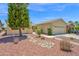 Inviting single-story home with a well-manicured front yard, desert landscaping, and a clean, attractive facade at 42485 W Abbey Rd, Maricopa, AZ 85138