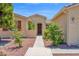 Inviting front entrance with a paved walkway, colorful bushes, and a charming, well-maintained exterior at 42485 W Abbey Rd, Maricopa, AZ 85138