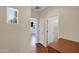 Bright hallway with a view into a bedroom showcasing natural light and neutral paint at 42485 W Abbey Rd, Maricopa, AZ 85138