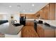 Spacious kitchen with an island, black appliances, and wooden cabinets at 42485 W Abbey Rd, Maricopa, AZ 85138