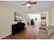 Open-concept living room showcases hardwood floors, a Yamaha keyboard, and flows into other living spaces at 42485 W Abbey Rd, Maricopa, AZ 85138
