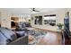 Open-concept living room with a view of the lake, comfortable sofas, and a stylish, seamless design at 42485 W Abbey Rd, Maricopa, AZ 85138