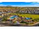 Beautiful aerial view of a community pool, landscaping, green space, and playground on a bright day at 4341 E Evelyn St, Gilbert, AZ 85295