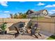 Cozy backyard seating area with brick pavers, firepit, and ambient string lights at 4341 E Evelyn St, Gilbert, AZ 85295