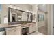 Elegant bathroom with double sinks, a makeup vanity, and a large mirror reflecting the luxurious shower at 4341 E Evelyn St, Gilbert, AZ 85295