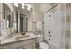 Bright bathroom with a shower-tub combo, white vanity, decorative plant, and neutral color palette at 4341 E Evelyn St, Gilbert, AZ 85295