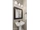 Stylish powder room featuring a bronze faucet, modern mirror, and neutral paint at 4341 E Evelyn St, Gilbert, AZ 85295