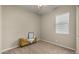 Simple bedroom with a yellow bench, neutral tones, and a soft carpet, ready for personalization at 4341 E Evelyn St, Gilbert, AZ 85295