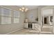 Well-lit dining area with a wine fridge, stylish light fixture and view to hall at 4341 E Evelyn St, Gilbert, AZ 85295