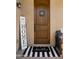 Inviting front entrance with a decorative door, striped doormat, and 'Welcome Home' sign at 4341 E Evelyn St, Gilbert, AZ 85295