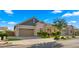 Beautiful home with a well-kept lawn, mature landscaping, and a three-car garage at 4341 E Evelyn St, Gilbert, AZ 85295