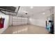 Clean, bright garage with epoxy floors, overhead storage racks, and a water heater at 4341 E Evelyn St, Gilbert, AZ 85295