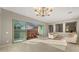Open-concept living room with chandelier and access to an outdoor patio at 4341 E Evelyn St, Gilbert, AZ 85295