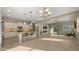 Open-concept living room with a kitchen, sleek fireplace, and sliding glass doors to the backyard at 4341 E Evelyn St, Gilbert, AZ 85295