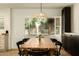 Well-lit dining room with wood table and a bay window at 547 W Orangewood Ave, Phoenix, AZ 85021