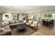 Bright, open-concept living room with modern furnishings that flows into kitchen area at 547 W Orangewood Ave, Phoenix, AZ 85021