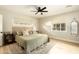 Serene bedroom with a neutral palette, natural light, and ceiling fan at 547 W Orangewood Ave, Phoenix, AZ 85021