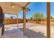A covered patio in a backyard with a wood fence and gravel at 6040 N 31St Dr, Phoenix, AZ 85017