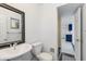 Cozy bathroom featuring white fixtures including a toilet and pedestal sink at 6040 N 31St Dr, Phoenix, AZ 85017