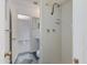 Small bathroom with a shower stall, white tile, and a view to the next room at 6040 N 31St Dr, Phoenix, AZ 85017