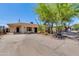 Charming single-story home featuring desert landscaping, mature trees, and a wide, expansive driveway at 6040 N 31St Dr, Phoenix, AZ 85017