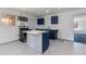 This kitchen has white tile floors, a tile island, blue lower cabinets, and gray upper cabinets at 6040 N 31St Dr, Phoenix, AZ 85017