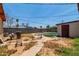 View of the backyard with concrete walkways leading to the shed at 6063 W Earll Dr, Phoenix, AZ 85033