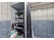 The bathroom space has built-in shelving for storage alongside the shower stall at 6063 W Earll Dr, Phoenix, AZ 85033