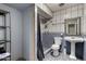 A simple bathroom with a tile shower and pedestal sink offers essential amenities at 6063 W Earll Dr, Phoenix, AZ 85033