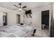 This bedroom features tiled floors, a ceiling fan, and a small bathroom connected to the main space at 6063 W Earll Dr, Phoenix, AZ 85033