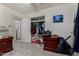 This bedroom has tile floors and an open closet for easy organization and storage at 6063 W Earll Dr, Phoenix, AZ 85033