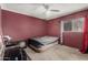 A simple bedroom space includes a single window and ceiling fan for basic comfort at 6063 W Earll Dr, Phoenix, AZ 85033