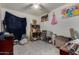 Bedroom with tile floor, ceiling fan, shelves, and princess-themed decor at 6063 W Earll Dr, Phoenix, AZ 85033