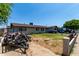 View of a single-story house featuring a well-manicured lawn, a private driveway, and a residential yard at 6063 W Earll Dr, Phoenix, AZ 85033