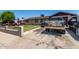 View of a single-story house featuring a well-manicured lawn, a private driveway, and a residential yard at 6063 W Earll Dr, Phoenix, AZ 85033