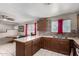 Kitchen with an island counter with stylish mosaic backsplash and stainless steel appliances at 6063 W Earll Dr, Phoenix, AZ 85033