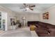 Comfortable living room with a brown sofa, area rug, and soft lighting, creating a relaxing and inviting atmosphere at 6063 W Earll Dr, Phoenix, AZ 85033