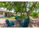 Inviting backyard with mature trees, outdoor seating, and a well-maintained lawn for activities and relaxation at 6232 N 88Th Ave, Glendale, AZ 85305