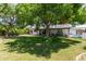 Spacious backyard with a swimming pool, mature trees, and ample space for recreation and leisure at 6232 N 88Th Ave, Glendale, AZ 85305