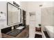 Modern main bathroom with dual vanity, soaking tub, and walk-in closet, offering spa-like experience at 6232 N 88Th Ave, Glendale, AZ 85305