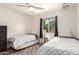 Bright bedroom with twin beds, neutral walls, and a view from the window at 6232 N 88Th Ave, Glendale, AZ 85305