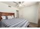 Comfortable bedroom featuring a full bed, wooden floors, and neutral colors at 6232 N 88Th Ave, Glendale, AZ 85305