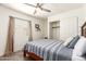 Cozy bedroom featuring a full bed, wooden floors, and a closet at 6232 N 88Th Ave, Glendale, AZ 85305