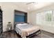Well-lit bedroom featuring a full bed with a convertible murphy bed frame at 6232 N 88Th Ave, Glendale, AZ 85305