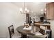 Cozy dining area near the kitchen featuring an updated chandelier at 6232 N 88Th Ave, Glendale, AZ 85305