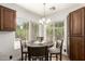 Charming breakfast nook with natural light and view of landscaped backyard, ideal for casual dining at 6232 N 88Th Ave, Glendale, AZ 85305
