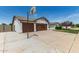 Spacious driveway featuring a basketball hoop with three-car garage and partial front exterior at 6232 N 88Th Ave, Glendale, AZ 85305